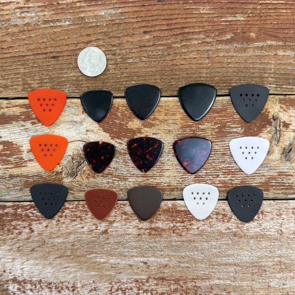woodtone different guitar pick shapes on wooden background