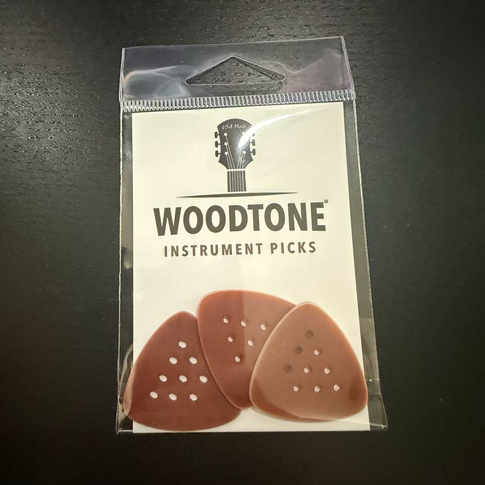 a three-pack of Woodtone small triangle guitar picks for playing country music chicken pickin'