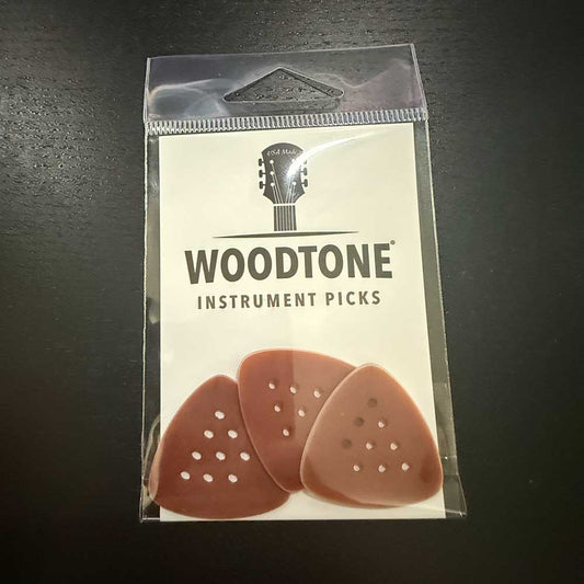 a three-pack of Woodtone small triangle guitar picks for playing country music chicken pickin'